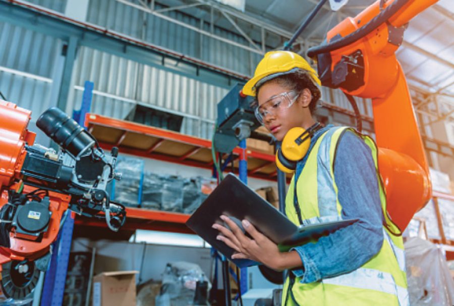 Skilled trades worker using a tablet in an industrial workshop